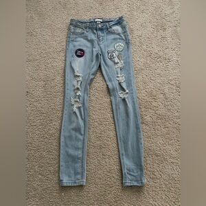 Distressed denim jeans with patches